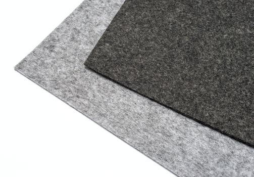 gray felt pieces on a white background
