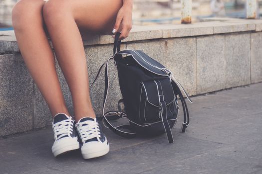 closeup of woman legs in white gumshoes, outdoor shot