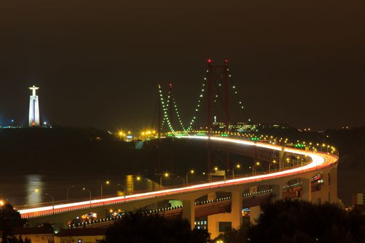 The 25 De Abril Bridge in Lisbon over Tagus River (Ponte 25 de Abril) at night motion blur