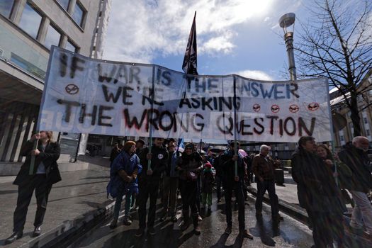 BELGIUM, Brussels: Protesters hold a banner during a demonstration against fighters jets purchase plan in Brussels on April 24, 2016.