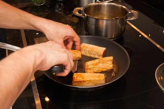 cook cut fried tuna slices on dripping pan