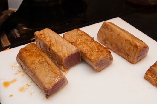 fried tuna slices on plastic platter