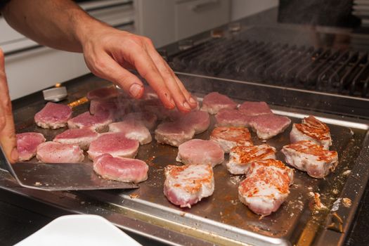 cook turn around grilled tuna meat on metallic pan