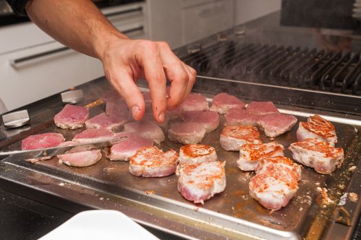 cook turn around grilled tuna meat on metallic pan