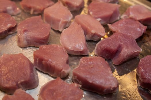 raw meat prepared for barbecue on metallic platter