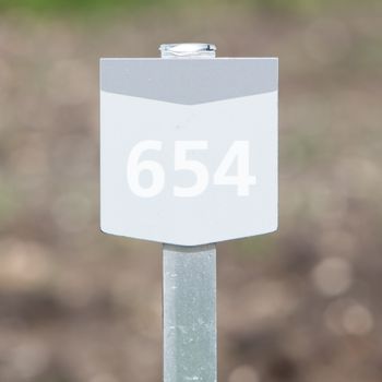 654 street number on a wooden bungalow