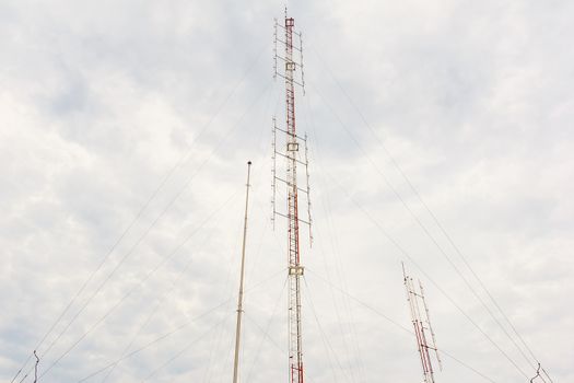 Radio tower with cloudy sky in background.