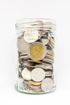 Thai coin in transparent jar without cover on white background.