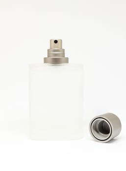 Perfume bottle made from opaque glass with cover beside.