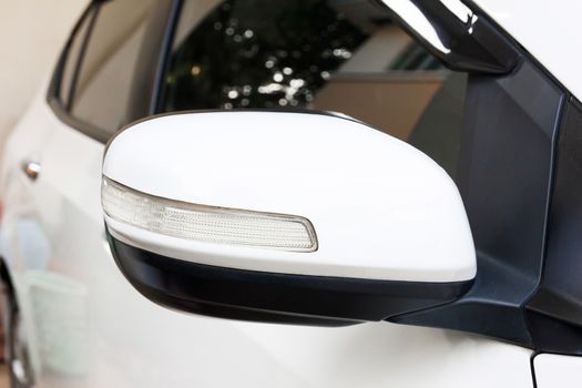 Back view of white car side mirror.