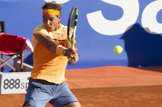 SPAIN, Barcelona: Spanish tennis player Rafael Nadal returns the ball to Japanese tennis player Kei Nishikori during the final of the ATP Barcelona Open Conde de Godo tennis tournament in Barcelona on April 24, 2015. Rafael Nadal equalled Argentine legend Guillermo Vilas's record of 49 clay-court titles with his ninth Barcelona Open after overcoming defending champion Kei Nishikori 6-4, 7-5 today. 