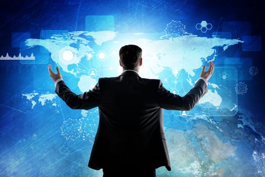 Rear view of businessman looking at digital screen with world map