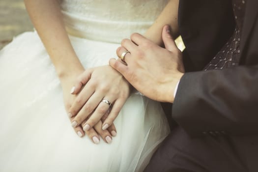 Unrecognizable couple of newly-married wearing wedding rings