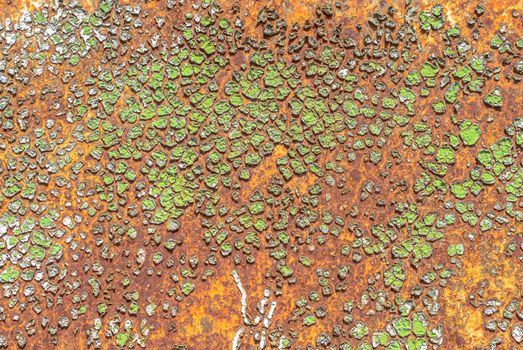 rusty iron surface covered with old chipped green color paint, which has long been influenced by different climatic conditions