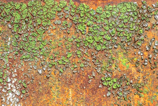 rusty iron surface covered with old chipped green color paint, which has long been influenced by different climatic conditions