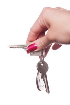 Close up of manicured fingers painted a deep glossy red curling around set of car keys