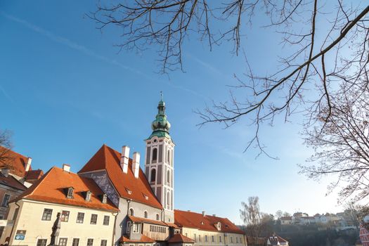 General Cesky Krumlov view with gothic towers and historical small houses around,  on bright sky background.