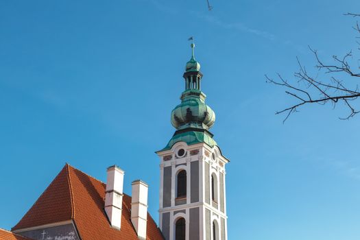 Close up detailed view of a gothic tower, on bright blue sky background.