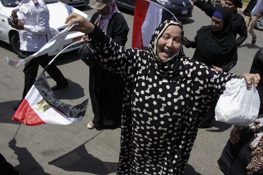 EGYPT, Giza: A woman chant as dozens gather in Mostafa Mahmoud Square in Giza, near Cairo on April 25, 2016 to commemorate the thirty-fourth anniversary of Sinai liberation. This same day, thousands of security personnel were deployed around Cairo ahead of mass planned protests over the return of two Red Sea islands to Saudi Arabia, a decision that has provoked some of the most open criticism of President Abdel-Fattah el-Sissi's leadership.