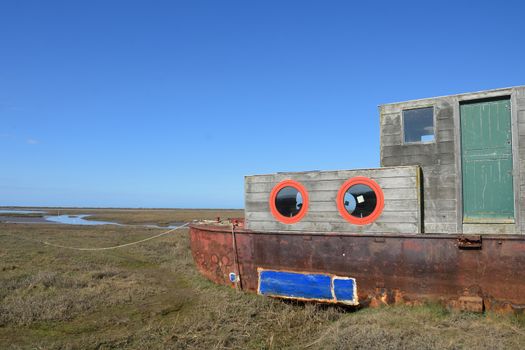 Rusty  old Houseboat overlooking estuary