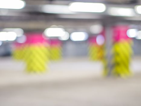 Parking garage underground, industrial interior. Neon light in bright industrial building.