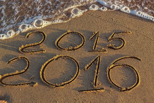 Happy New Year 2016 replace 2015 concept on the sea beach 