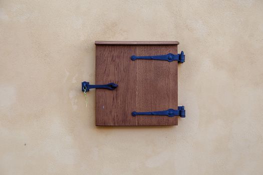 Close up detailed view of old wooden door on a white wall.