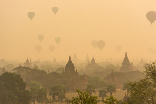 Hot air balloon over plain of Bagan in misty morning before sunrise, Myanmar