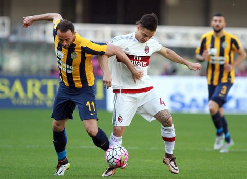 ITALY, Verona: Hellas Verona's forward Giampaolo Pazzini (L) vies with Milan's midfielder Jose Mauri during the Serie A match between FC Hellas Verona v AC Milan on April 25, 2016. Luca Siligardi scored on a late free kick to secure the win for his team in the 95th minute.