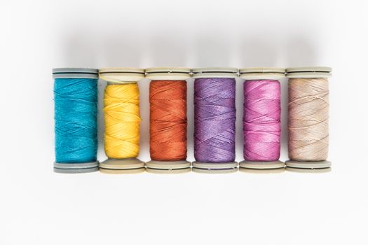 Multi-colored threads, sewing kit, a set of tailor on white background