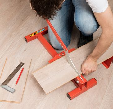 Red tool for cutting laminate on a laminate floor