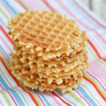 Stack Belgian waffles on a colored striped tablecloths