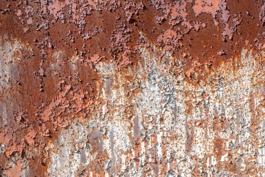 rusty iron surface covered with old chipped paint, which has long been influenced by different climatic conditions