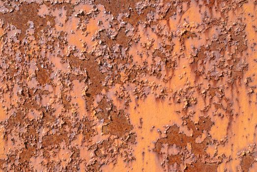 rusty iron surface covered with old chipped paint, which has long been influenced by different climatic conditions