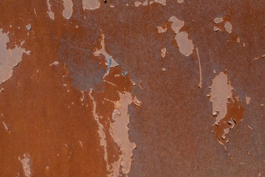 rusty iron surface covered with old chipped paint, which has long been influenced by different climatic conditions