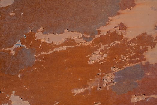 rusty iron surface covered with old chipped paint, which has long been influenced by different climatic conditions