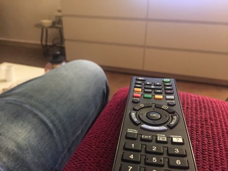 Black Remote control on a red couch