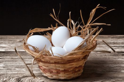 White chicken eggs in basket close up