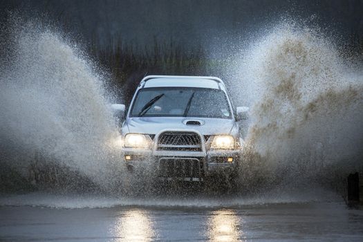 Driving through floodwater on a dull winter's day on a country road in North Yorkshire in the United Kingdom.