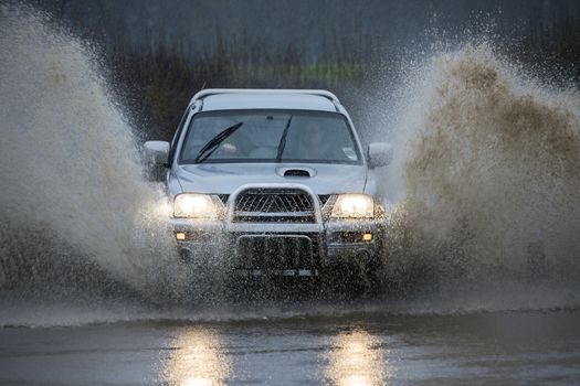 Driving through floodwater on a country road in North Yorkshire in the United Kingdom.