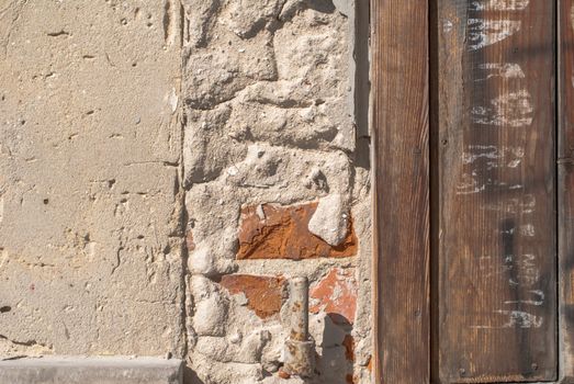 fragment of a brick wall, which has undergone deformation due to prolonged exposure to various climatic conditions