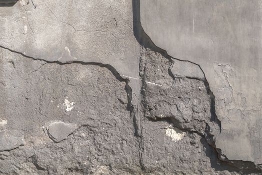 fragment of a concrete wall, which has undergone deformation due to prolonged exposure to various climatic conditions