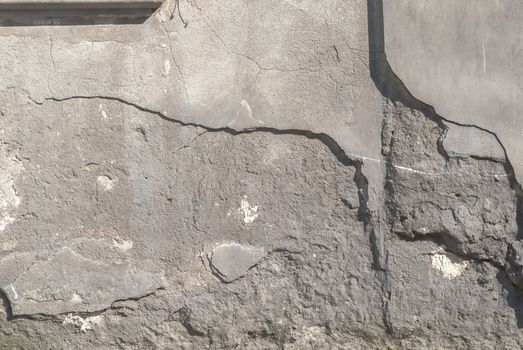 fragment of a concrete wall, which has undergone deformation due to prolonged exposure to various climatic conditions