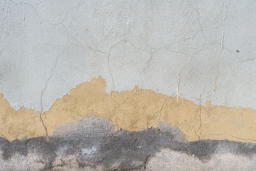 fragment of a concrete wall, which has undergone deformation due to prolonged exposure to various climatic conditions