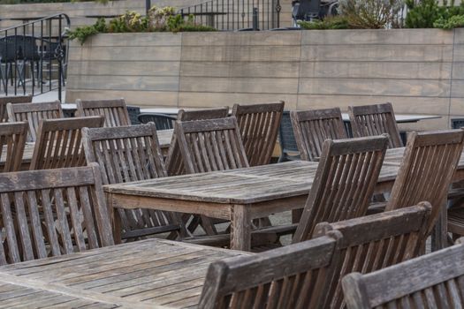 Beer garden wooden tables on the terrace of a restaurant.