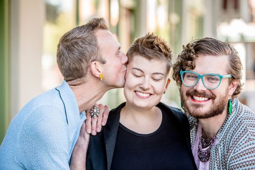 A kiss among attractive gender fluid friends