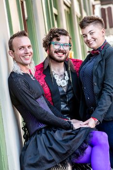 Smiling gender fluid trio of young friends