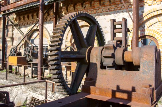 Old rusty gears, machinery parts.