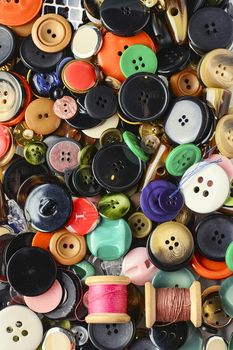 Set of various sewing buttons and thread.Top view