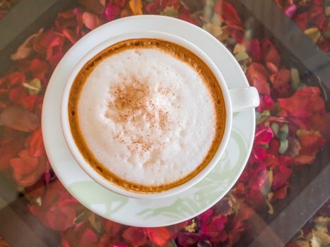 Close up white cup of Coffee, latte on the wooden glasses table